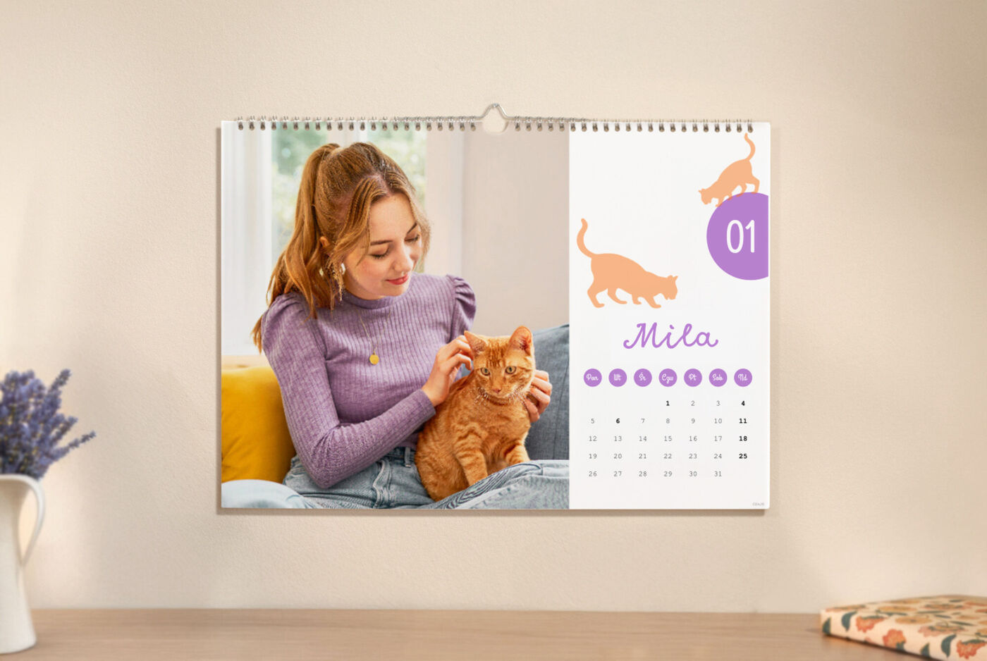 Calendario de pared personalizado con foto de mujer y gato naranja, nombre "Mila" e ilustraciones de gatos en tonos lila.